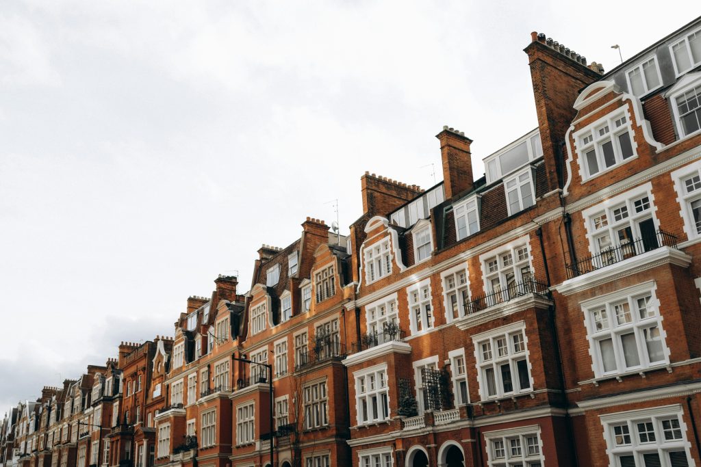 Classic red brick terraced houses in a residential district of London, UK.