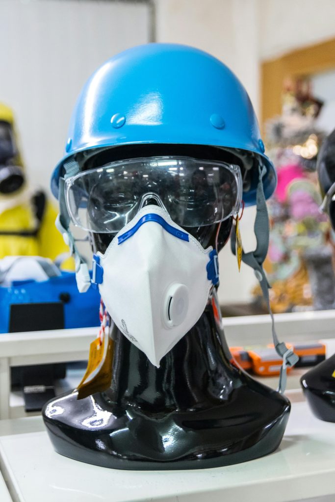 Mannequin showcasing blue helmet, goggles, and mask for safety and protection.