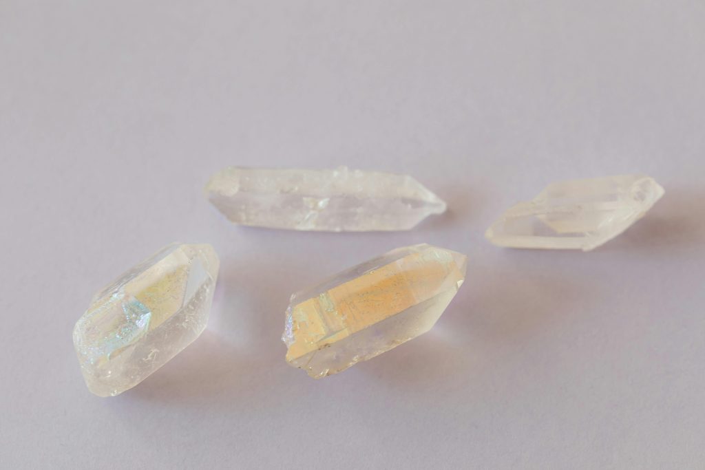 Elegant translucent quartz crystals displayed on a pale surface, highlighting texture and clarity.