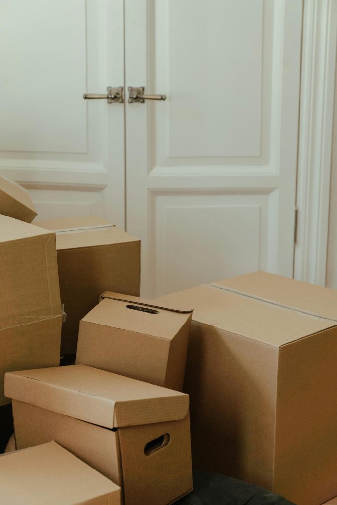 Cardboard boxes stacked in an apartment, signifying a move-in or relocation process.