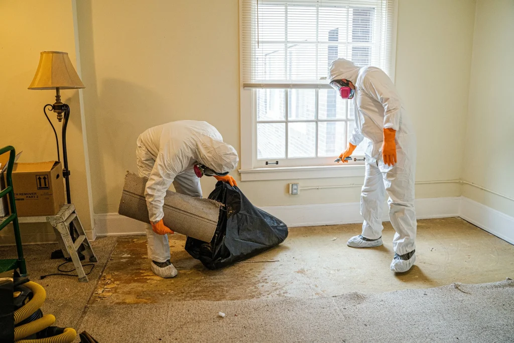 technician disinfecting room after unattended death cleaning